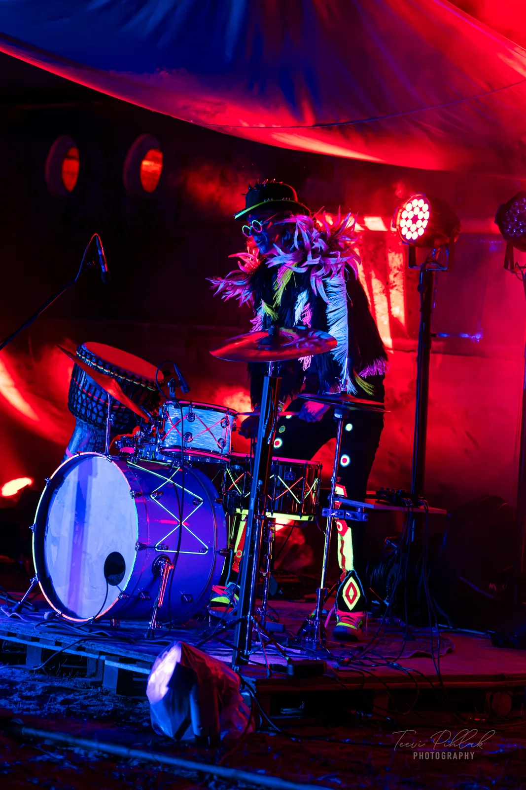 Silver Ulvik drumming in a feathered costume